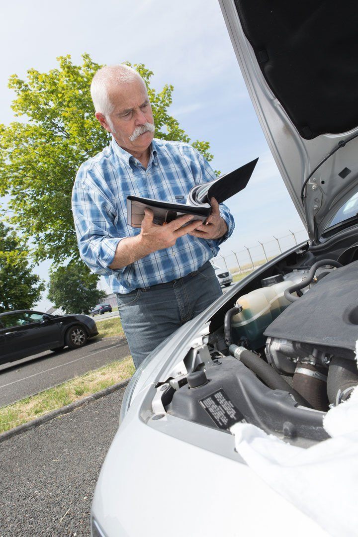 man-using-vehicle-checklist-adobe-stock