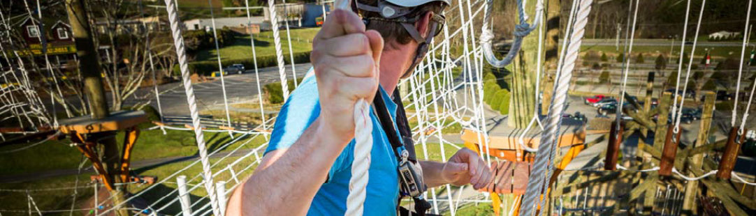 young man climbing on ropes at High Gravity Adventures aerial adventure park