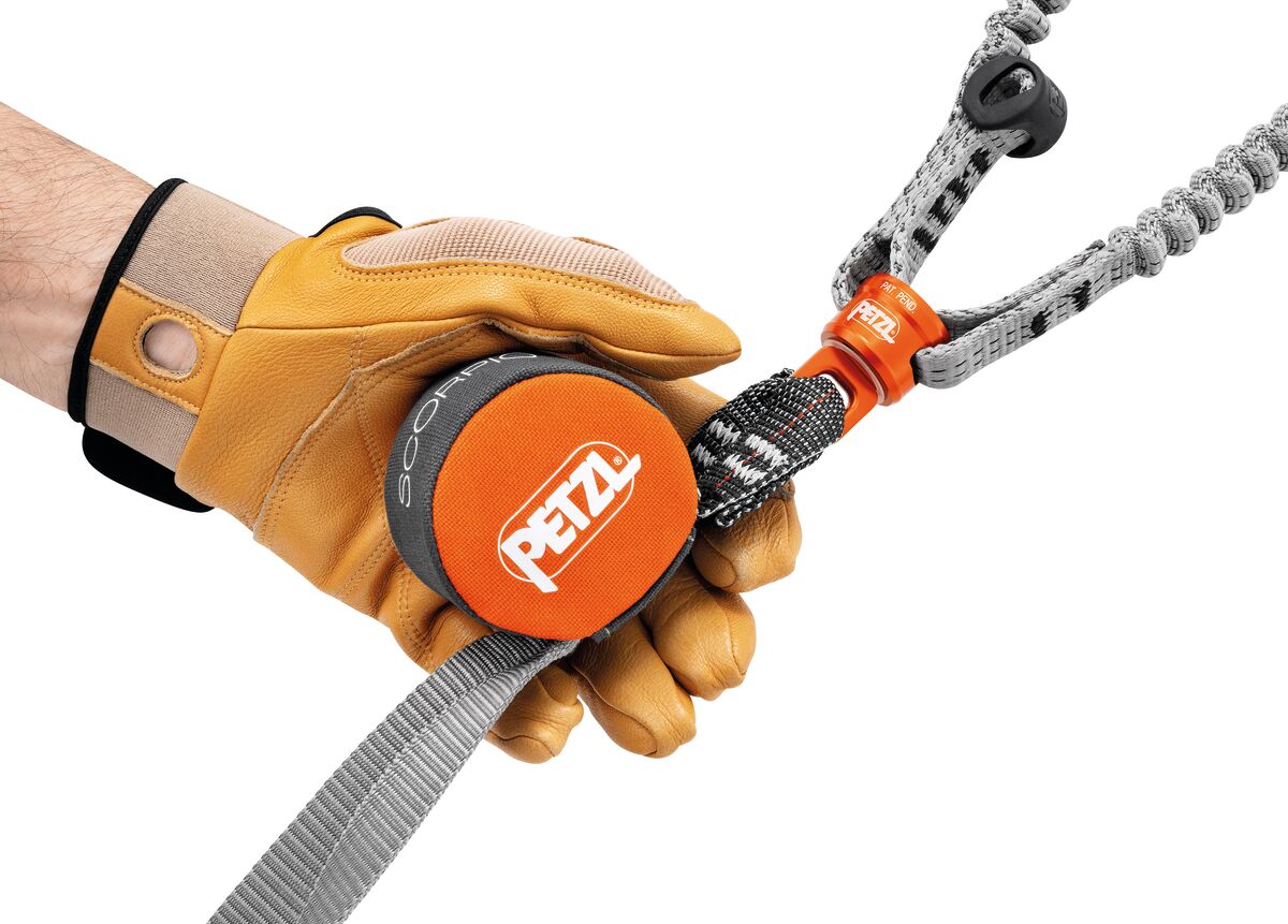 Petzl Scorpio Vertigo lanyard held by a gloved hand demonstrating its lightweight and compact design.